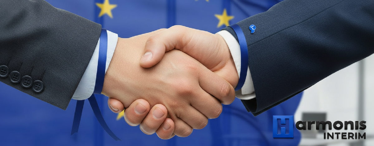 Poignée de main devant le drapeau européen, coopération France-Roumanie.